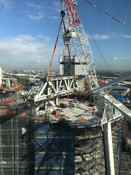 A crane lifting steel on a building construction project